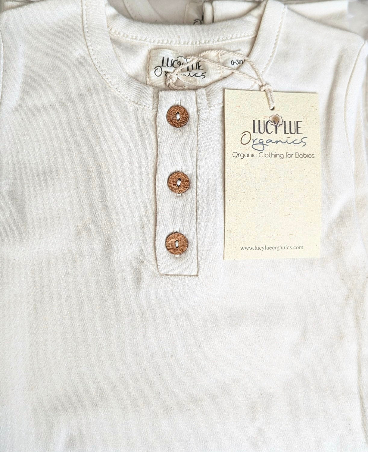 small details up close of organic baby romper coverall one piece for boy girl infants