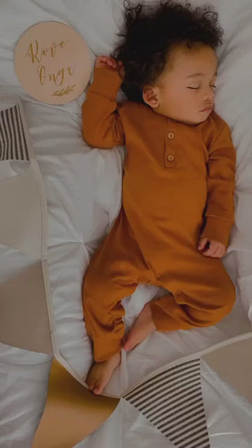 Organic baby clothes, sleeping baby, lucy lue Organics, modern baby clothes, organic baby clothes brand, long sleeve romper, button baby romper, baby boy romper, baby girl romper, earth tone baby clothes, black owned baby brand, gender neutal baby clothes, spearmint baby, 