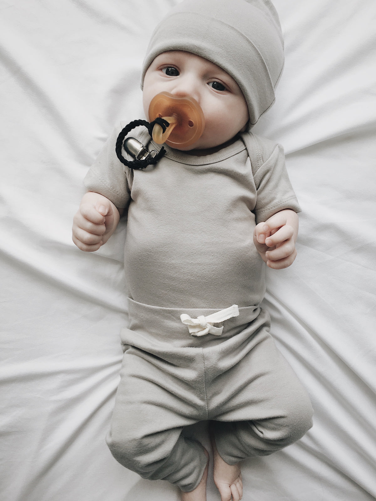 Lucy Lue Organics. Ivory organic bodysuit. Organic baby clothes. Organic newborn outfit. Organic cotton. Organic kids clothes. Organic baby fashion. Ethical clothing. Gender neutral colors. Minimalist modern baby style. Organic Baby products.