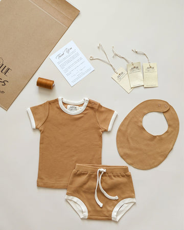 Organic Cotton Onesies. Made with 100% GOTS-certified organic cotton. Matching baby sets with bloomers and baby bibs