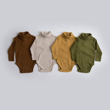 Turtleneck baby bodysuits. Lucy Lue Organics. Winter baby clothes. organic ribbed Long sleeve bodysuits. Mock neck bodysuits . Organic baby clothes. Neutral baby bodysuits. Earth tone onesies